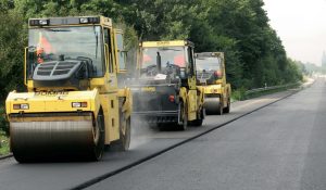 Asphalt rollers drives over new layer of asphalt